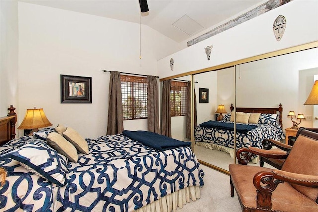 carpeted bedroom featuring vaulted ceiling, a closet, and ceiling fan