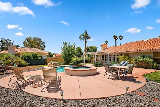 exterior space with a patio and an in ground hot tub