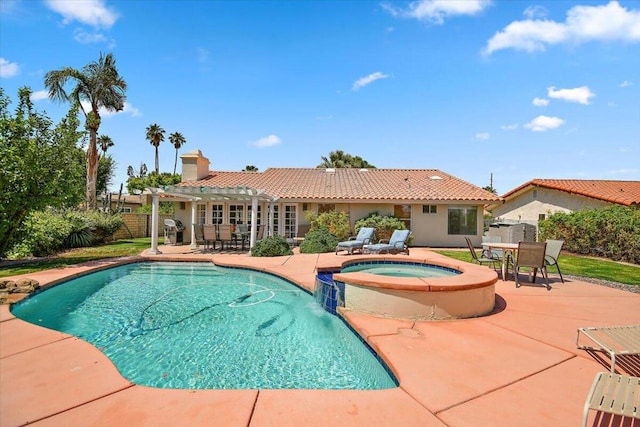 view of swimming pool featuring a patio area, an in ground hot tub, and area for grilling