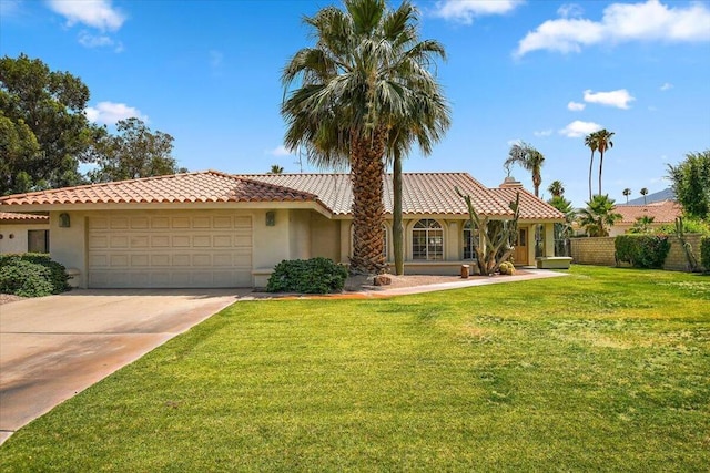 view of front of home featuring a front lawn and a garage