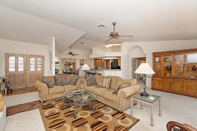 carpeted living room featuring ceiling fan and vaulted ceiling