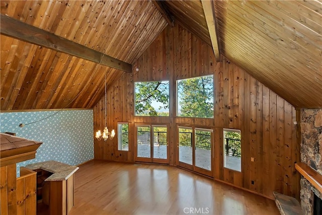 additional living space featuring a wealth of natural light, beamed ceiling, high vaulted ceiling, wood finished floors, and wooden ceiling