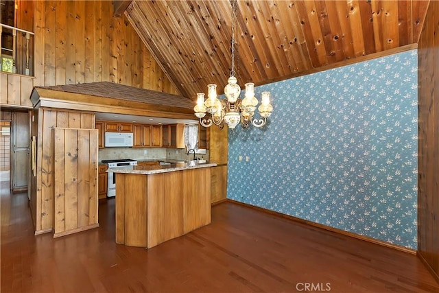 kitchen featuring brown cabinets, white appliances, dark wood-type flooring, and a peninsula