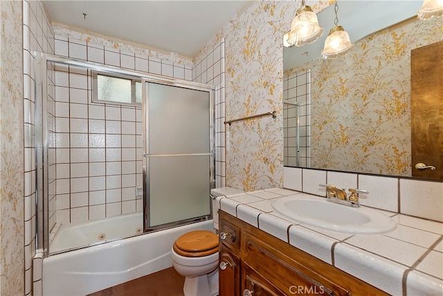 full bathroom featuring vanity, enclosed tub / shower combo, and toilet