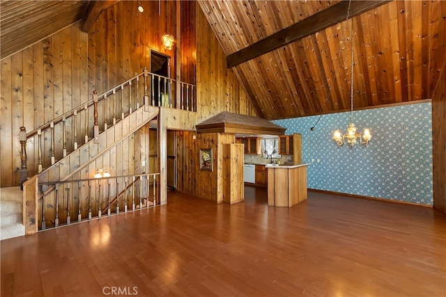 unfurnished living room featuring hardwood / wood-style flooring, wood ceiling, beamed ceiling, high vaulted ceiling, and a chandelier