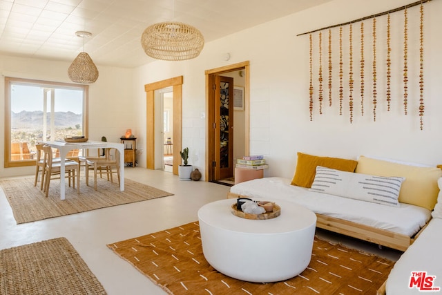 living room with a mountain view and concrete flooring