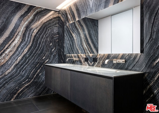 bathroom featuring dual vanity, tile walls, and tile floors