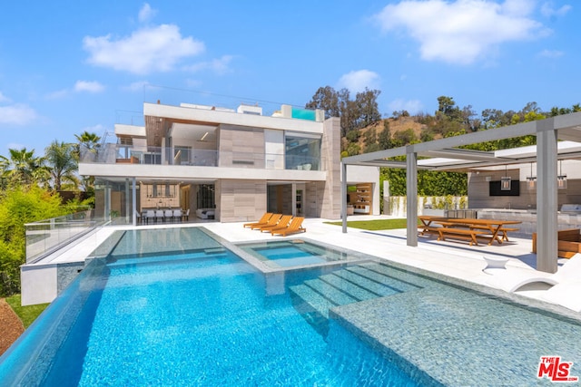 view of swimming pool with an in ground hot tub and a patio