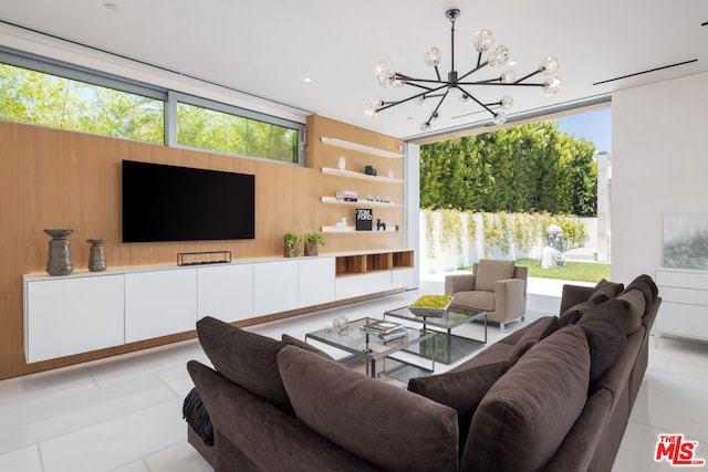 tiled living room with a notable chandelier