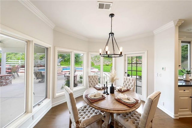 dining space with dark hardwood / wood-style flooring, crown molding, and plenty of natural light