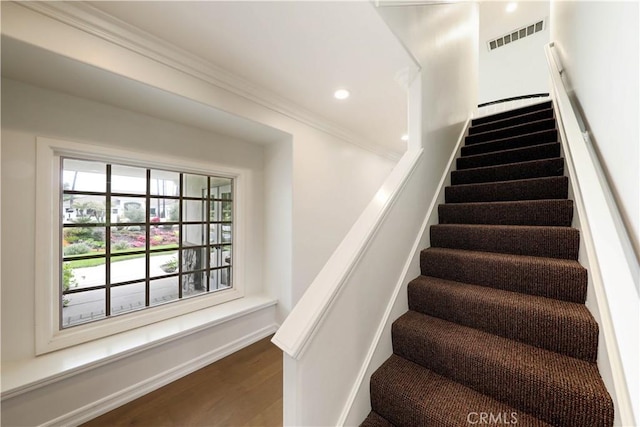 stairway featuring hardwood / wood-style flooring and ornamental molding