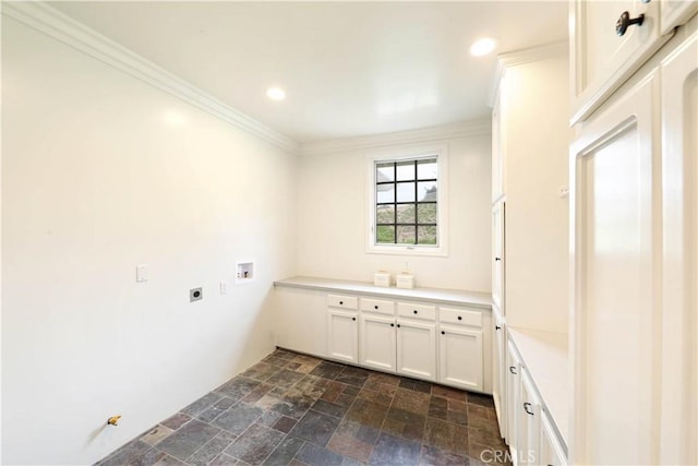 laundry room with electric dryer hookup, crown molding, hookup for a washing machine, and cabinets