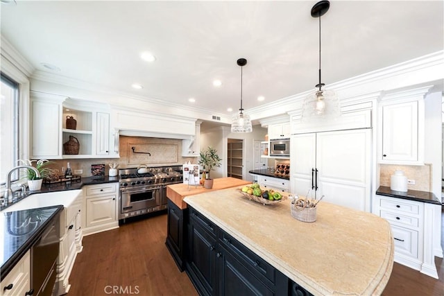 kitchen featuring white cabinetry, a center island, dark wood-type flooring, built in appliances, and decorative light fixtures