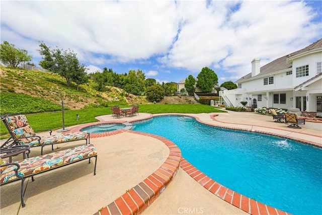 view of swimming pool with a lawn, an in ground hot tub, and a patio