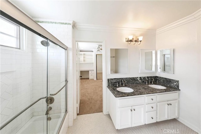 bathroom featuring crown molding, tile patterned flooring, vanity, and combined bath / shower with glass door