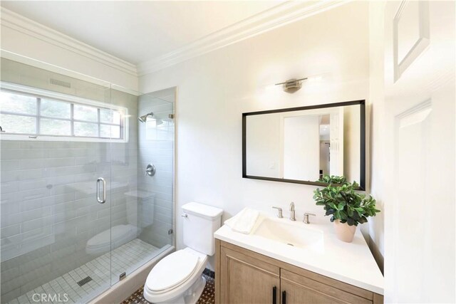 bathroom featuring vanity, toilet, an enclosed shower, and crown molding