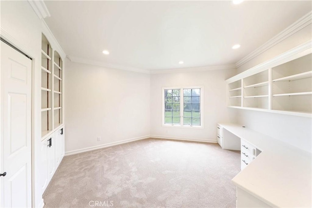 unfurnished office featuring light carpet and crown molding