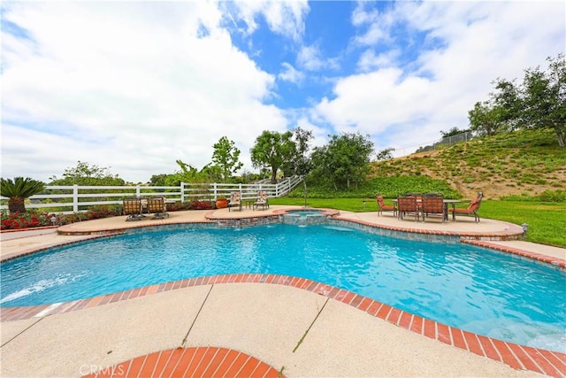 view of swimming pool with an in ground hot tub and a patio area