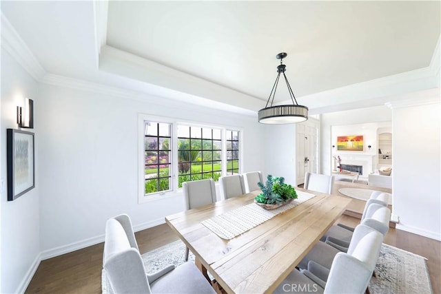 dining space with dark hardwood / wood-style floors and crown molding