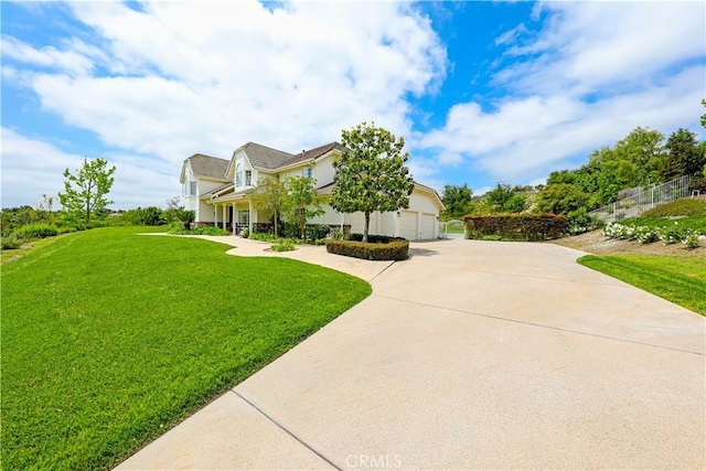 view of front of property featuring a garage and a front lawn