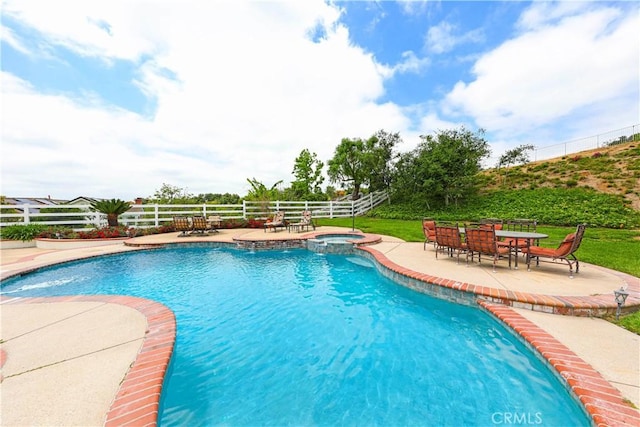 view of swimming pool featuring an in ground hot tub and a patio