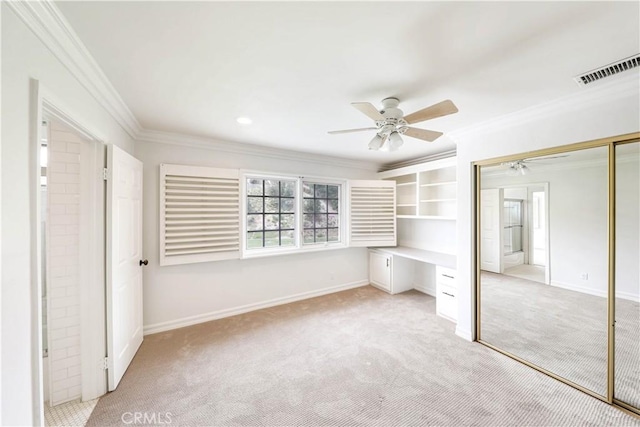 unfurnished bedroom featuring ceiling fan, a closet, light carpet, and ornamental molding