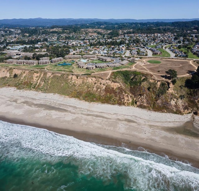 birds eye view of property with a water view and a view of the beach