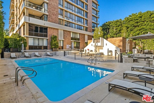 view of swimming pool with a patio area