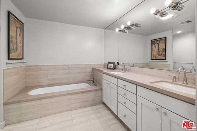 bathroom featuring tile floors, dual sinks, a relaxing tiled bath, and oversized vanity