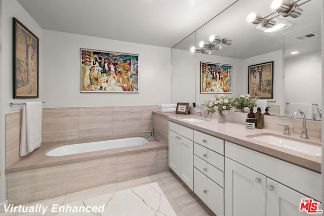 bathroom with tile flooring, a relaxing tiled bath, large vanity, and double sink