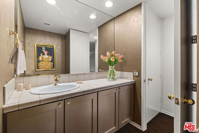 bathroom with hardwood / wood-style floors and vanity