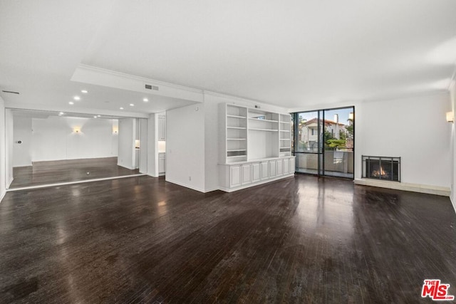 unfurnished living room featuring dark hardwood / wood-style floors