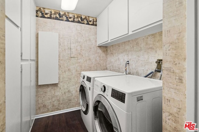 clothes washing area with dark wood-type flooring, cabinets, washer hookup, and washing machine and clothes dryer