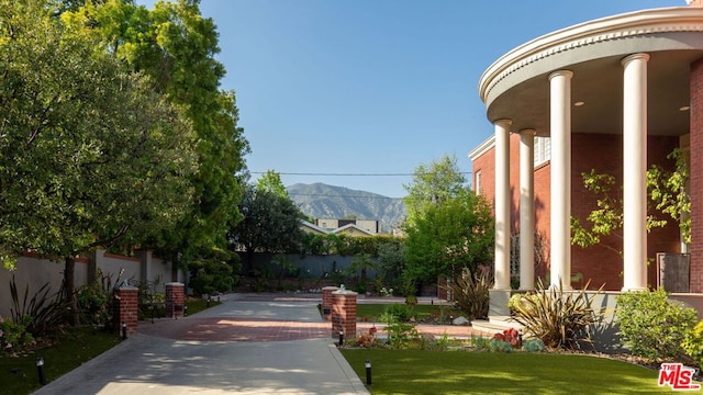 exterior space with a mountain view and a lawn