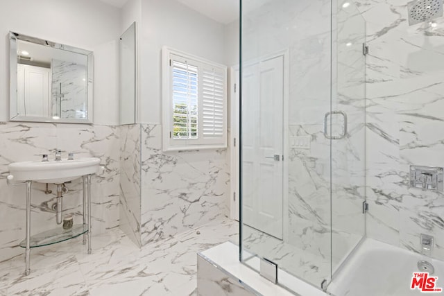 bathroom featuring sink and tile walls