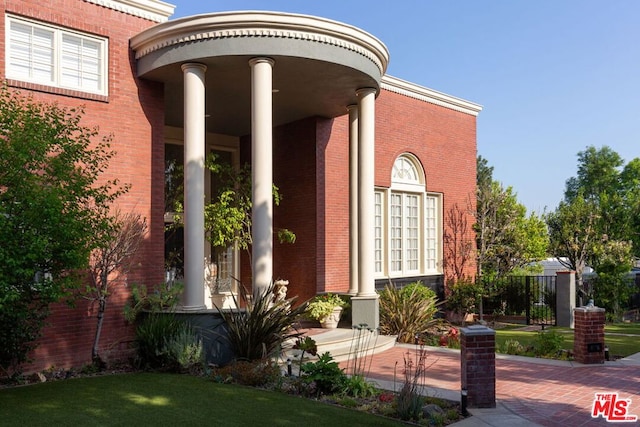 view of exterior entry with a yard