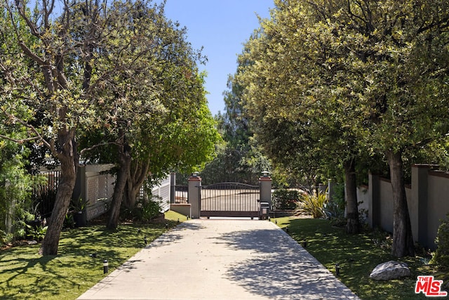 view of gate featuring a yard