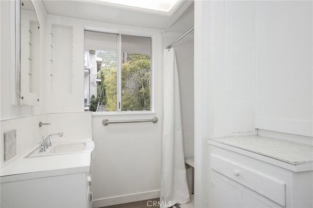 bathroom featuring shower / bath combination with curtain and vanity