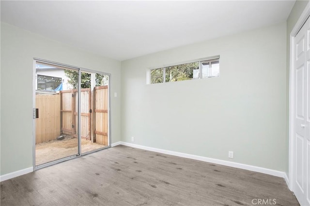 spare room with wood-type flooring