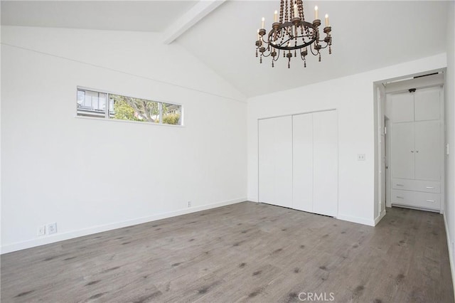 unfurnished bedroom featuring a notable chandelier, vaulted ceiling with beams, wood-type flooring, and a closet