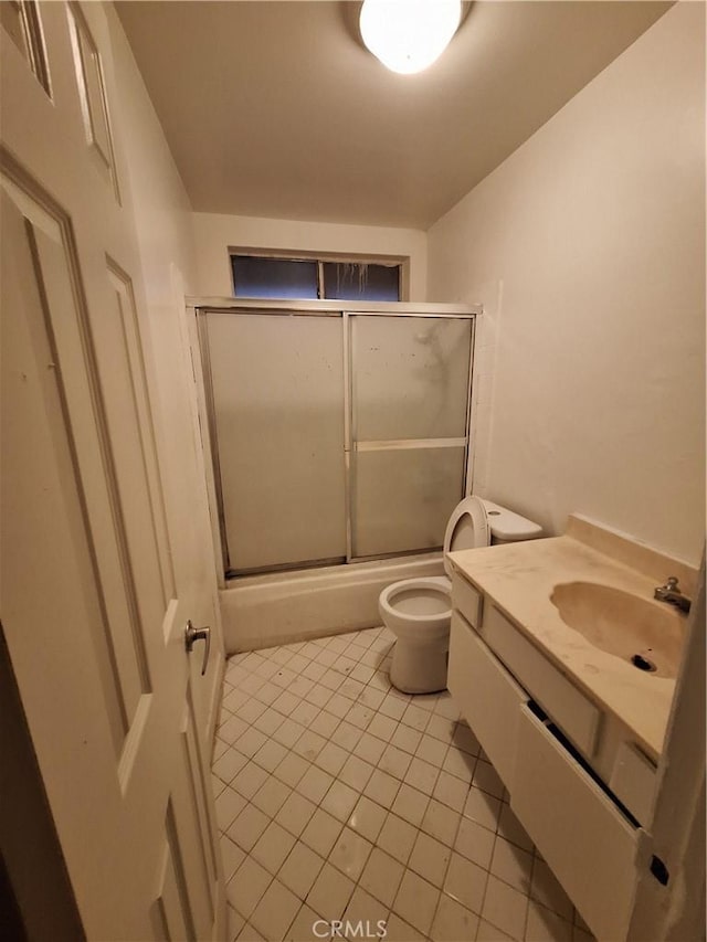 full bathroom featuring tile patterned flooring, vanity, toilet, and enclosed tub / shower combo