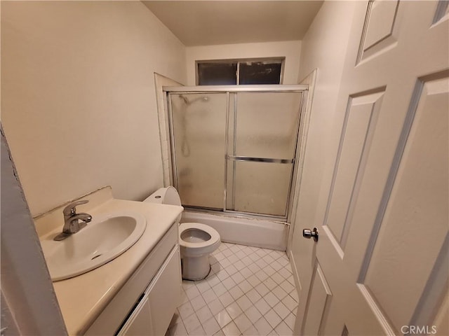 full bathroom featuring shower / bath combination with glass door, tile patterned floors, vanity, and toilet