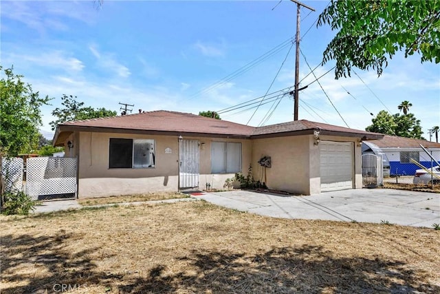 315 S Mistletoe Ave, San Jacinto, CA 92583 - view of front of home featuring stucco siding, an attached garage, and driveway