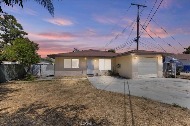 315 S Mistletoe Ave, San Jacinto, CA 92583 - view of front of property featuring stucco siding, an attached garage, and driveway