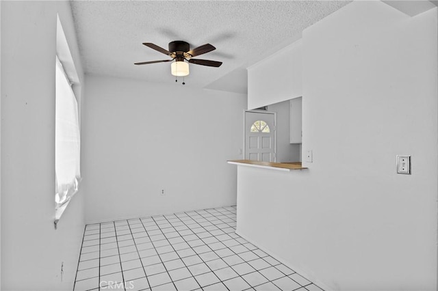 315 S Mistletoe Ave, San Jacinto, CA 92583 - empty room with a ceiling fan, a textured ceiling, and light tile patterned floors