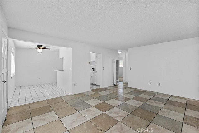 315 S Mistletoe Ave, San Jacinto, CA 92583 - unfurnished living room featuring a textured ceiling, a ceiling fan, and a sink