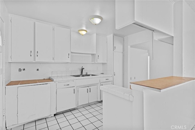 315 S Mistletoe Ave, San Jacinto, CA 92583 - kitchen featuring a sink, open shelves, white cabinetry, and a peninsula