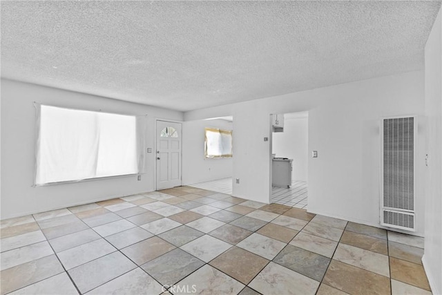 315 S Mistletoe Ave, San Jacinto, CA 92583 - unfurnished living room featuring a heating unit and a textured ceiling