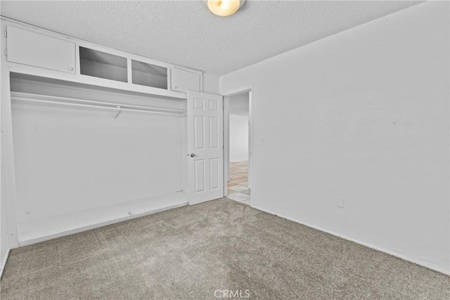 315 S Mistletoe Ave, San Jacinto, CA 92583 - unfurnished bedroom with carpet, a textured ceiling, and a closet