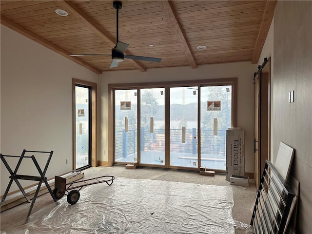 interior space with vaulted ceiling with beams, ceiling fan, a mountain view, wood ceiling, and a barn door